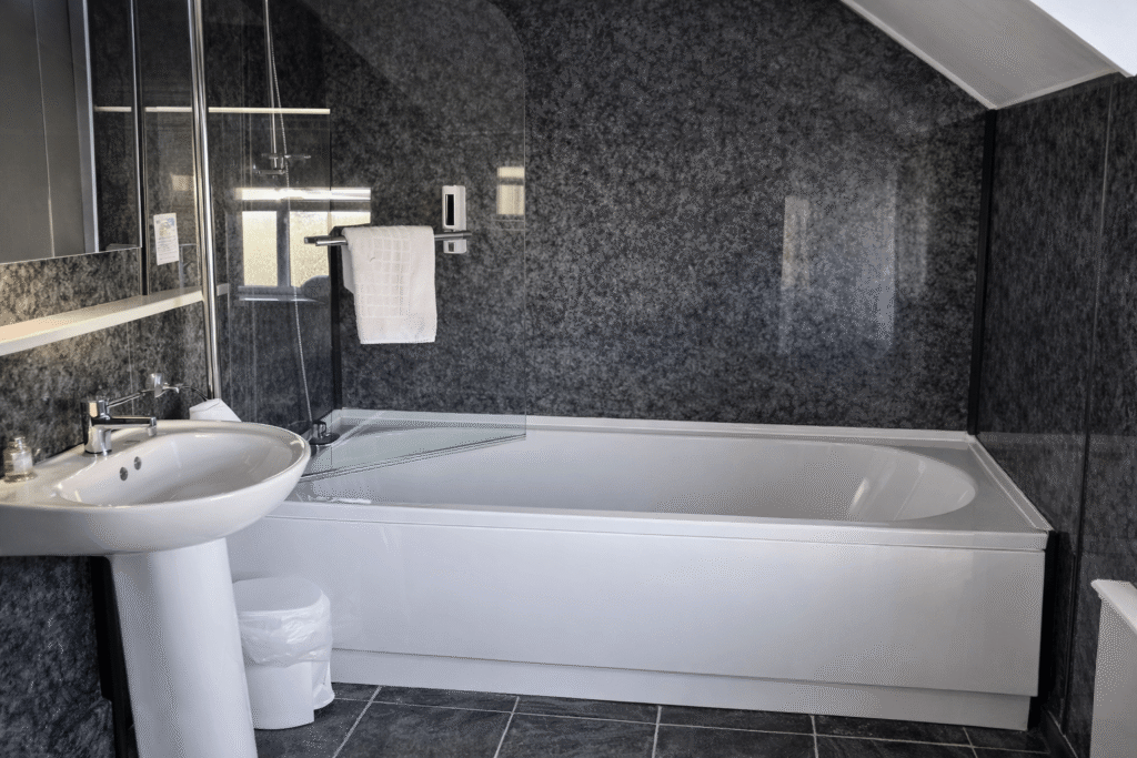 Modern bathroom with bath and shower at Valley Hotel Anglesey