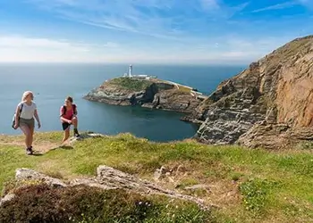 Information card describing the Anglesey Coast Path and its scenic walking routes around the island.