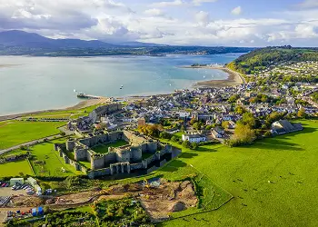 Information card about Beaumaris, featuring its castle, seafront and independent shops on Anglesey.