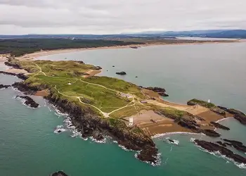 Information card about Newborough Beach and Llanddwyn Island, known for scenic walks and coastal views on Anglesey.